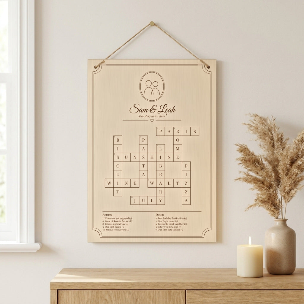 Personalised wooden crossword board engraved with a couple's names, hanging on jute twine