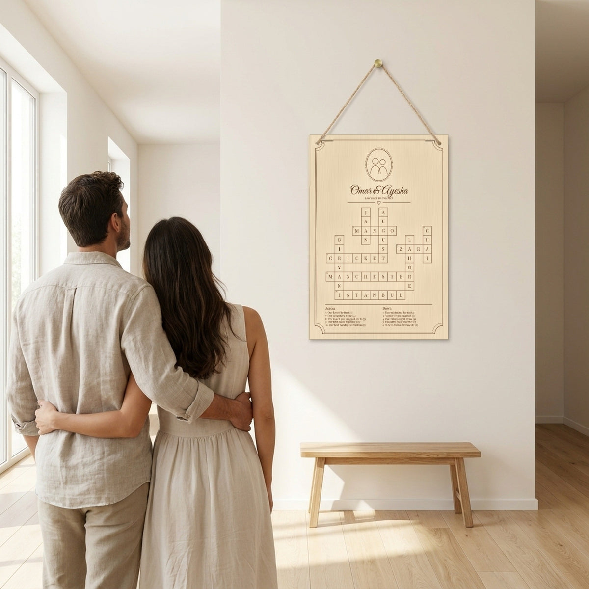 Couple admiring their personalised crossword on the wall