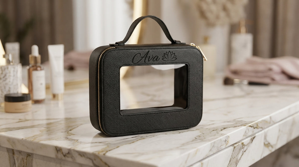 Black clear make-up bag engraved above the window with Ava in script and a lotus