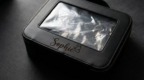 Black clear make-up bag engraved with Sophie in script and a butterfly below the window