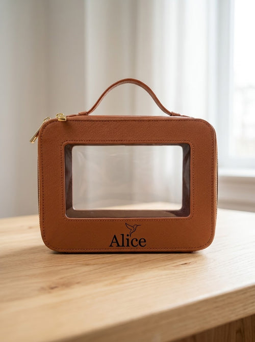 Tan clear make-up bag engraved with Alice and a hummingbird below the window