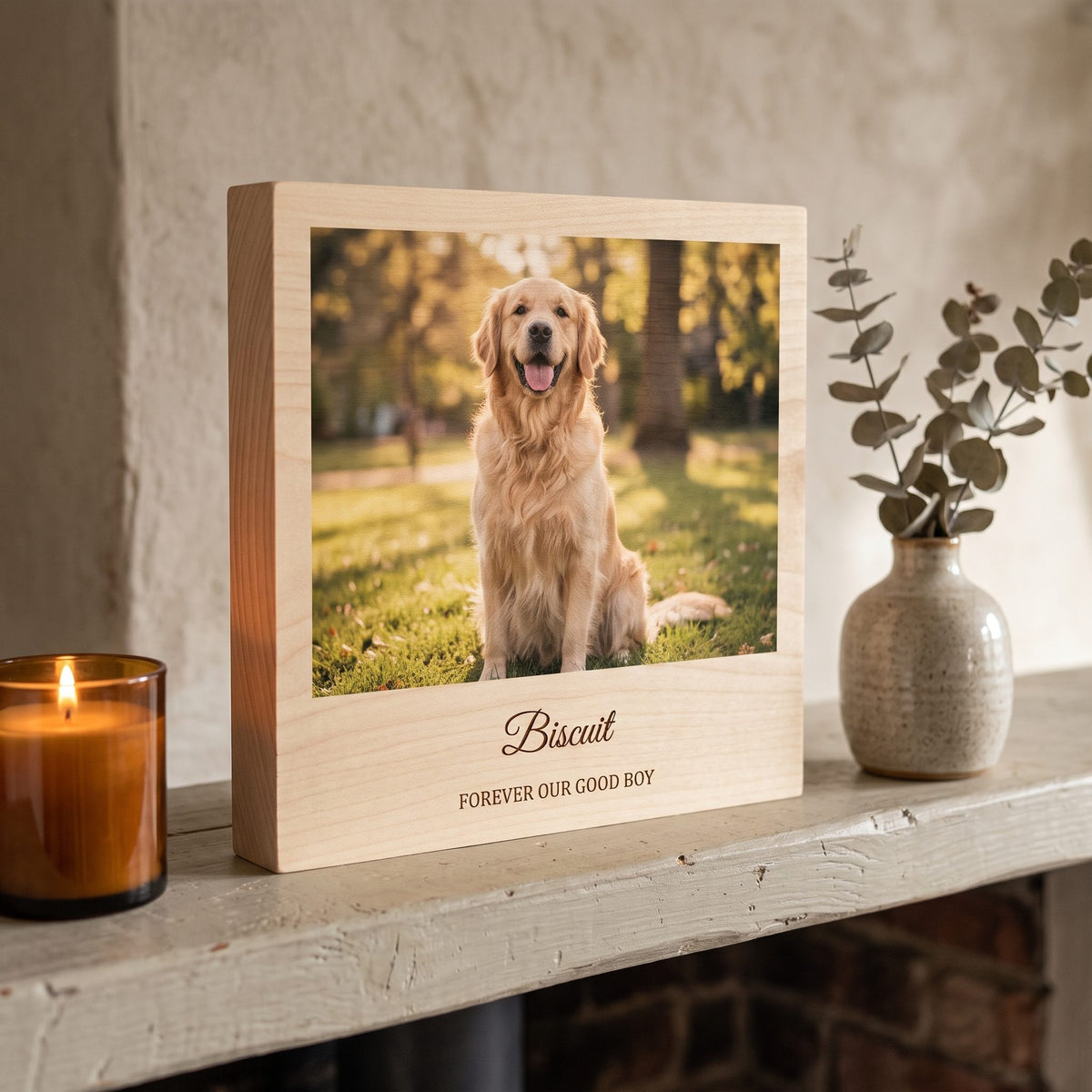 Wooden photo block with a golden retriever photo and the engraved name Biscuit on a mantelpiece