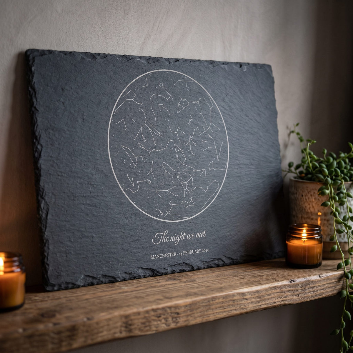 Star map on slate on a living-room shelf with candles