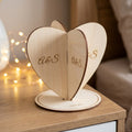 Personalised 3D heart keepsake with A & S initials and date on a bedside table