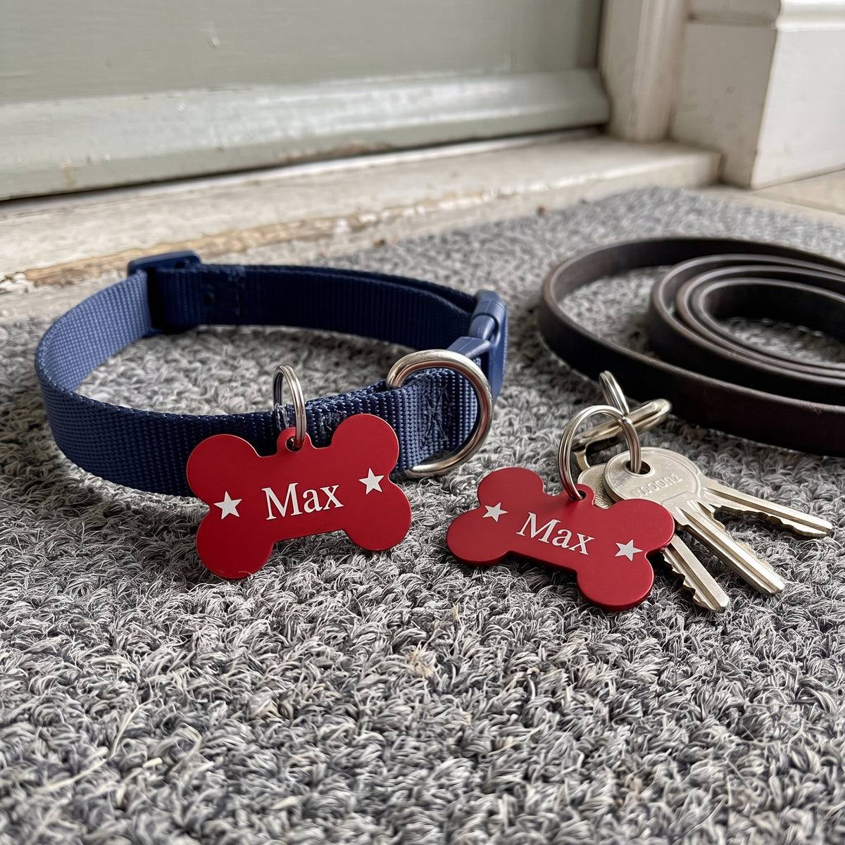 Matching red bone tags engraved Max: one on a dog collar, one on a house keyring