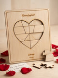 Personalised 'Piece of My Heart' puzzle standing in its frame with rose petals and a Valentine's card