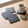 Set of four personalised slate coasters engraved Sarah & James with a heart and wedding date, with a coffee mug