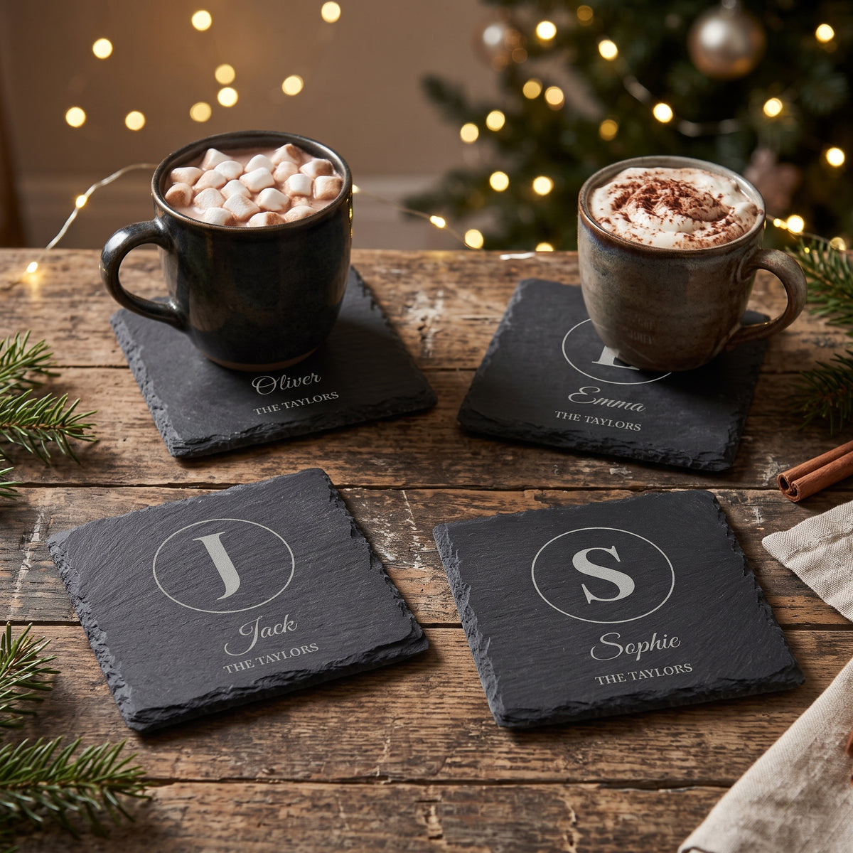 Family set of four slate coasters with a different initial and name on each, at Christmas with hot chocolate