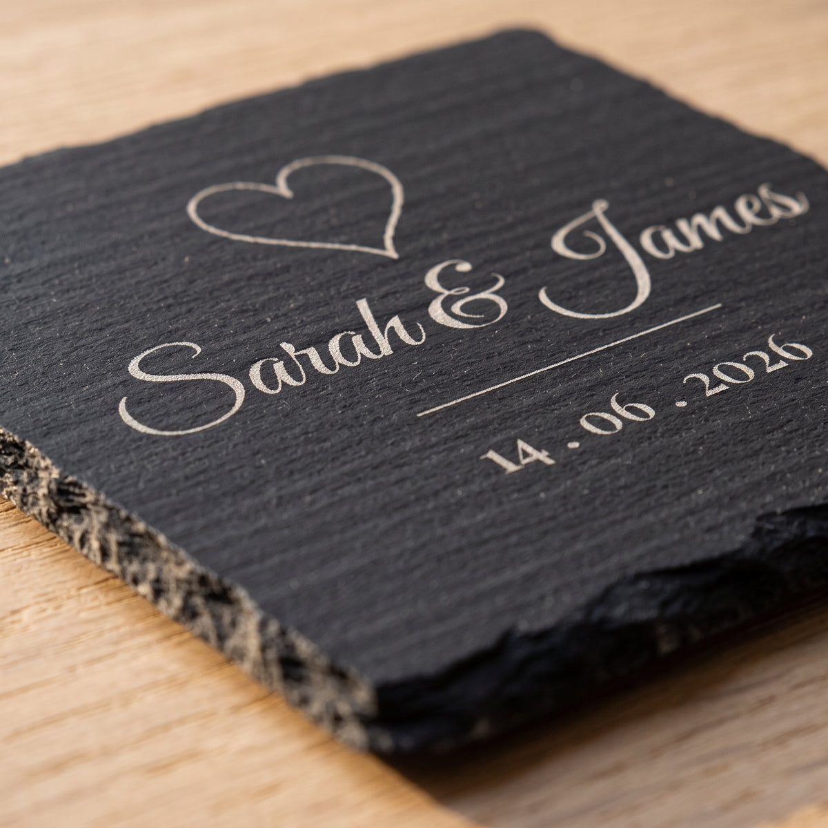 Close-up of the pale grey laser engraving on natural slate